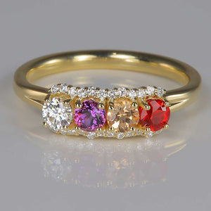 four natural birthstones in yellow gold ring with diamonds